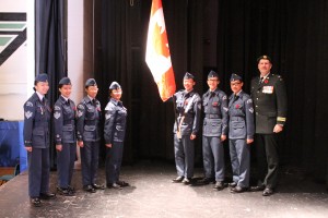 Student members of the Cadets Organization a pose respectfully holding the Canadian flag